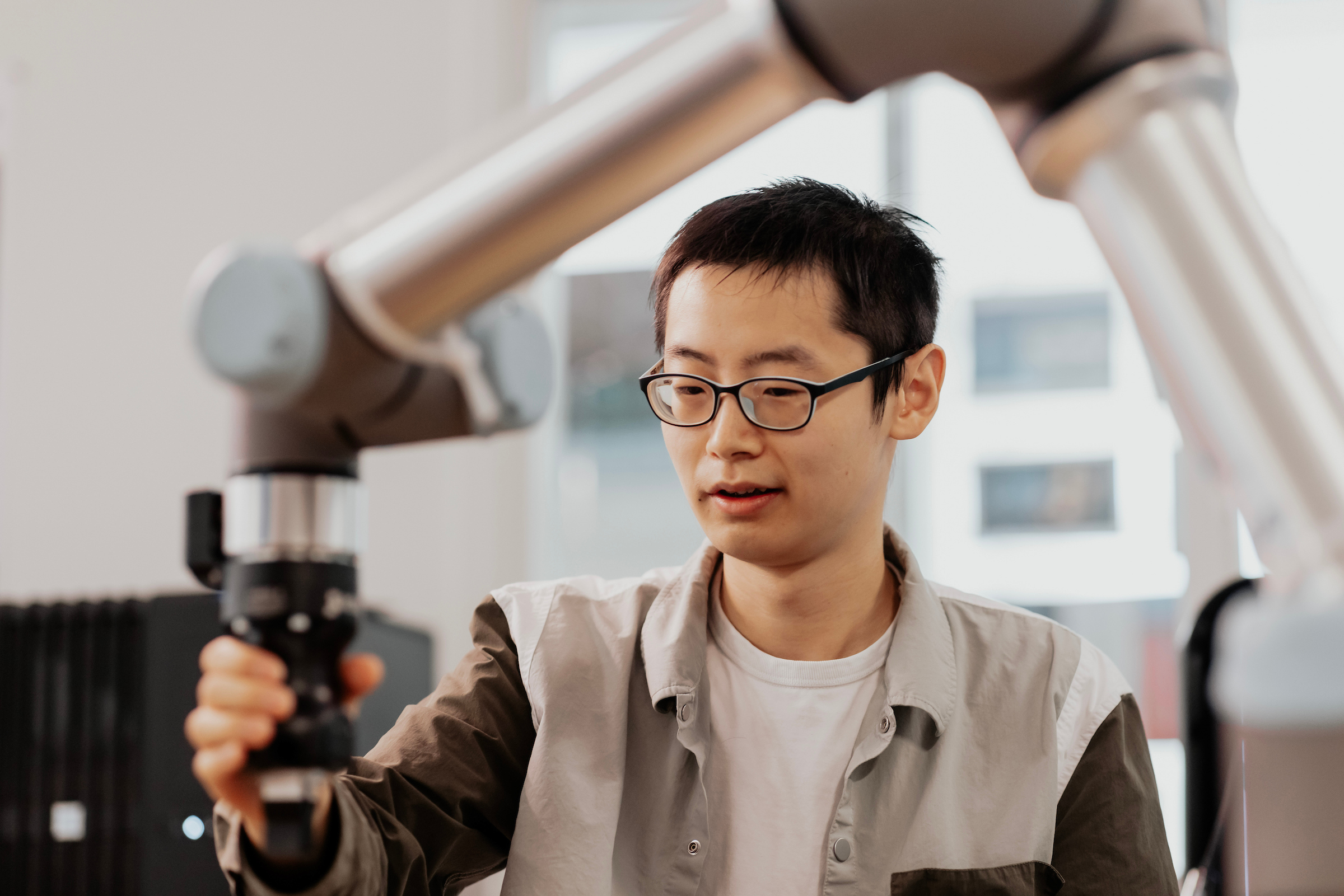 Robotics student with robotic arm